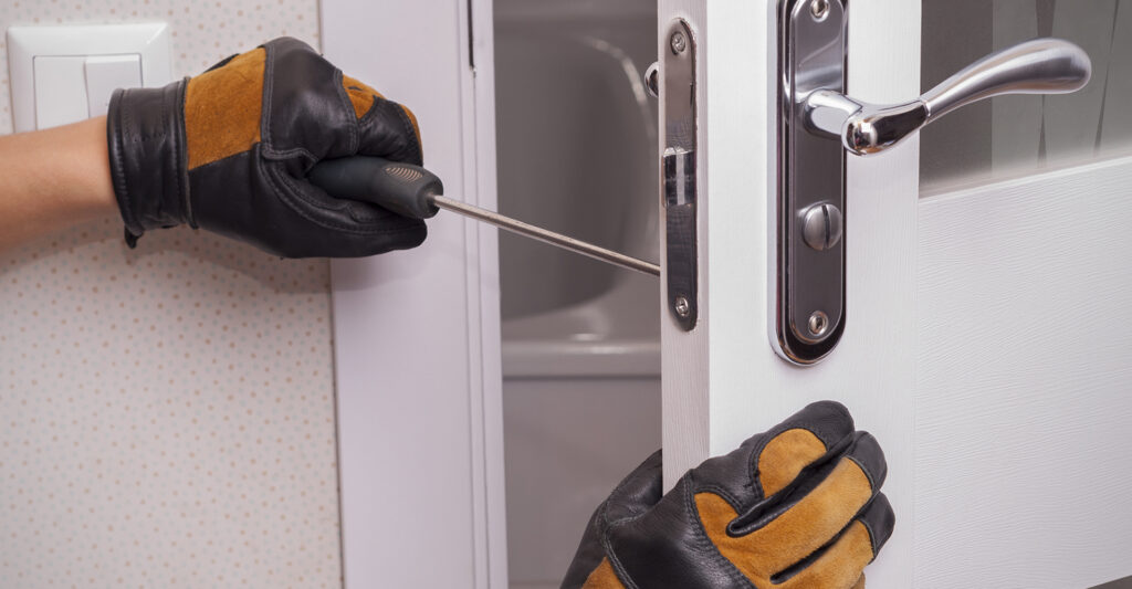 image of a person fixing a broken door